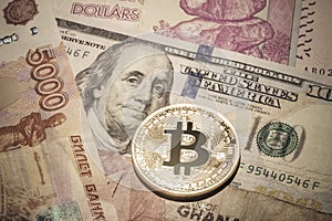 One Bitcoin on multicurrency banknotes.