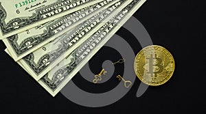 One bitcoin and US dollars with keys