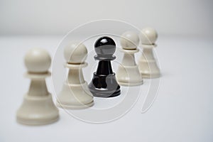 One Black Pawn Figure Among White Pawns Figure in a Line. Chess Concept