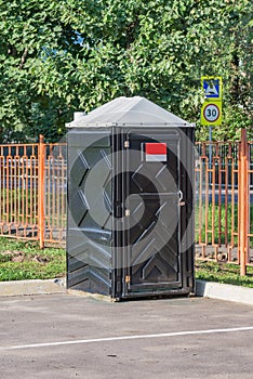 One black plastic toilet cabin