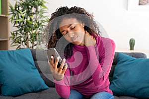 One black woman suffering having poor posture using mobile phone