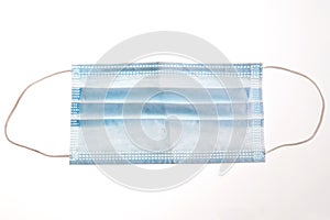 One blue face protection medical mask isolated on white background.