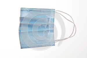 One blue face protection medical mask isolated on white background.