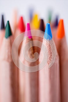 One blue pencil standing out from the other pencils. Leadership, uniqueness, independence, initiative,