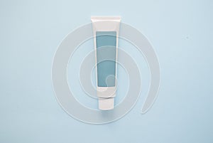 one blue tube cream of personal care cosmetics on a blue background