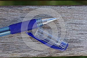 One blue white writing pen made of metal and plastic