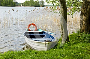 One boat on lake with life buoy
