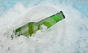 One bottle of cold lager beer on crushed ice