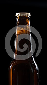 One bottle of fresh beer with drops on black