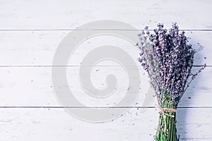 One bouquet of lavender flowers on a white wooden table