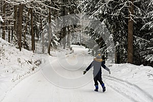 One boy happy runs in the forest  walk in the fresh winter air