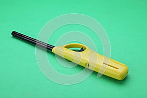 One bright gas lighter on green background