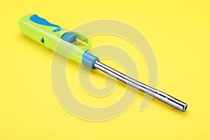 One bright gas lighter on yellow background