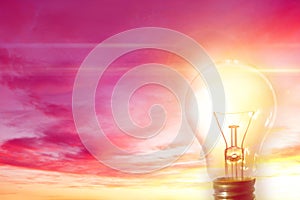 Glowing lightbulb in sky