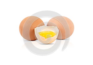 One broken egg and two whole eggs isolated on a white background