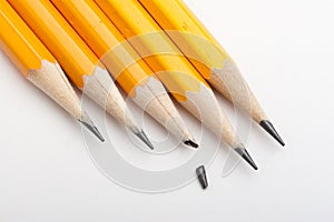 One broken point among sharp pencils