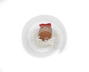 One egg with bow knot and nest made with white crumped paper laces photo