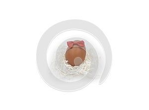 One egg with bow knot and nest made with white crumped paper laces photo