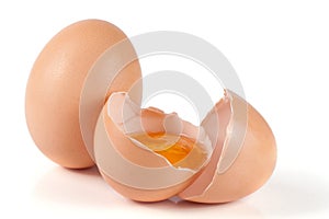 One brown egg and broken egg isolated on white background