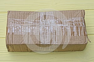 one brown paper closed rectangular parcel cardboard box