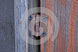 One brown small rusty iron door hinge