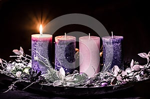 One burning candle on advent wreath