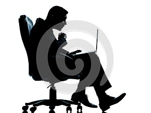one business man computer computing surprised sitting in armchair silhouette