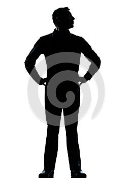 One business man standing hands on hips silhouette