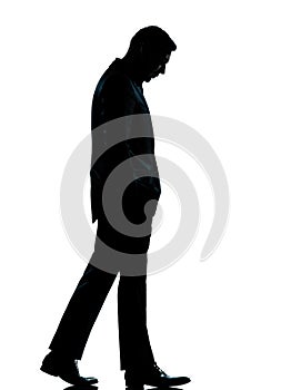 One business man walking looking down silhouette