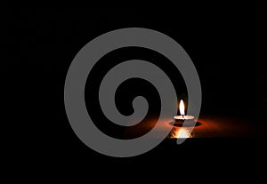 One Candle light on black background