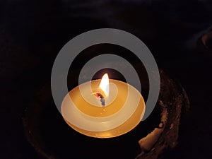 One candle light in the night on dark background. Light of candles backgrounds