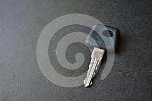 One car key on a black background