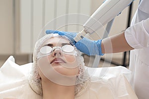 Laser Procedures Ideas. Caucasian Woman Getting Cosmetology Laser Facial Beauty Treatment While Removing Pigmentation in Clinic