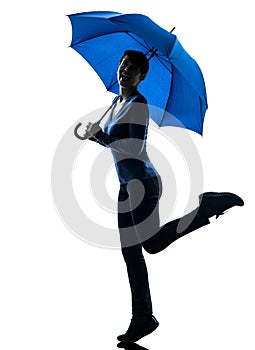 Woman happy holding umbrella silhouette