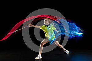 One caucasian young teenager girl woman playing Badminton player on black background