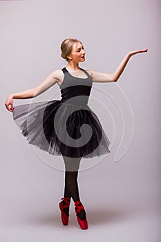 One caucasian young woman ballerina ballet dancer dancing with tutu in silhouette studio