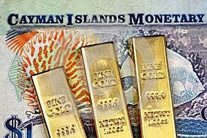 A one Cayman Islands bank note with three small gold bars