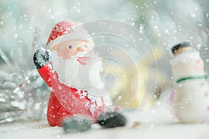 One ceramic santa claus Merry Christmas text on snowfall background. Lovely Merry Christmas and Happy New Year 2018 on snowfall