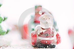 One ceramic santa claus Merry Christmas text on snowfall background. Lovely Merry Christmas and Happy New Year on snowfall.