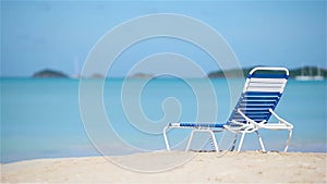 One chaise-longue on white tropical caribbean beach