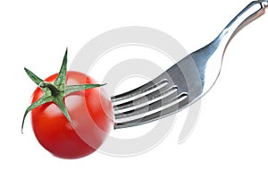 One cherry tomato on a fork over white