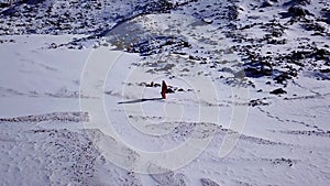 One climber is walking among the snowy mountains.