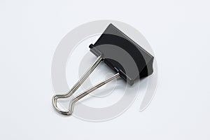 A one clip for papers. A black clip on white background.