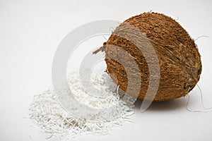 One coconut with white shredded pulp.