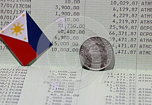 One coin of Philippine peso money on reverse and mini Philippine flag on the book bank. Concept of Saving money