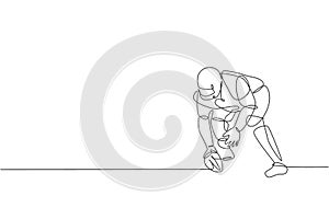 One continuous line drawing of sporty american football player stance to pass the ball to his team for competition poster. Sport