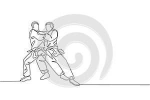 One continuous line drawing of two young sporty men training judo technique at sport hall. Jiu jitsu battle fight sport