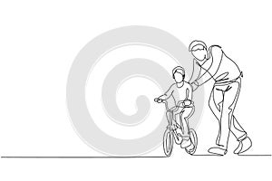 One continuous line drawing of young father help his son learning to ride a bicycle at countryside together. Parenthood lesson
