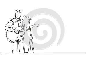 One continuous line drawing of young happy male guitarist playing acoustic guitar and singing on music festival stage. Musician