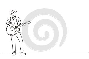 One continuous line drawing of young happy male guitarist wearing hat and playing acoustic guitar on street road. Trendy musician